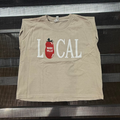 A beige sleeveless crop top with a graphic reading 'LOCAL' in white letters and a red tomato illustration, displayed on a dark metal rack.