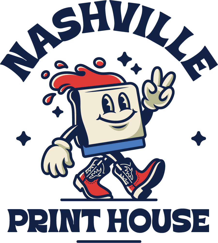 A stylized logo featuring the words “NASHVILLE PRINT HOUSE” in dark blue lettering with a cartoon print-on-demand character in the center. The character has a cream-colored square body, red splatter details, blue pants, and red-and-white sneakers, set against a plain white background.